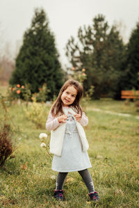 Portrait of smiling girl standing on field