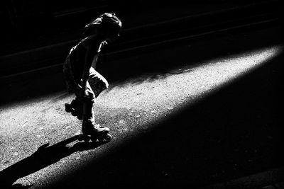 Full length of man skateboarding on floor