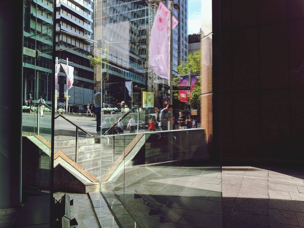 STREET SEEN THROUGH GLASS WINDOW ON FOOTPATH