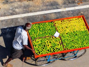 High angle view of man selling fruits outdoors