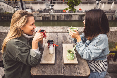 Portrait of smiling young woman drinking coffee