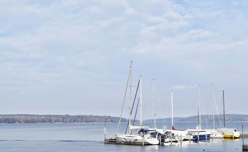 Boats moored in sea against sky