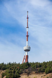 Low angle view of communications tower against sky