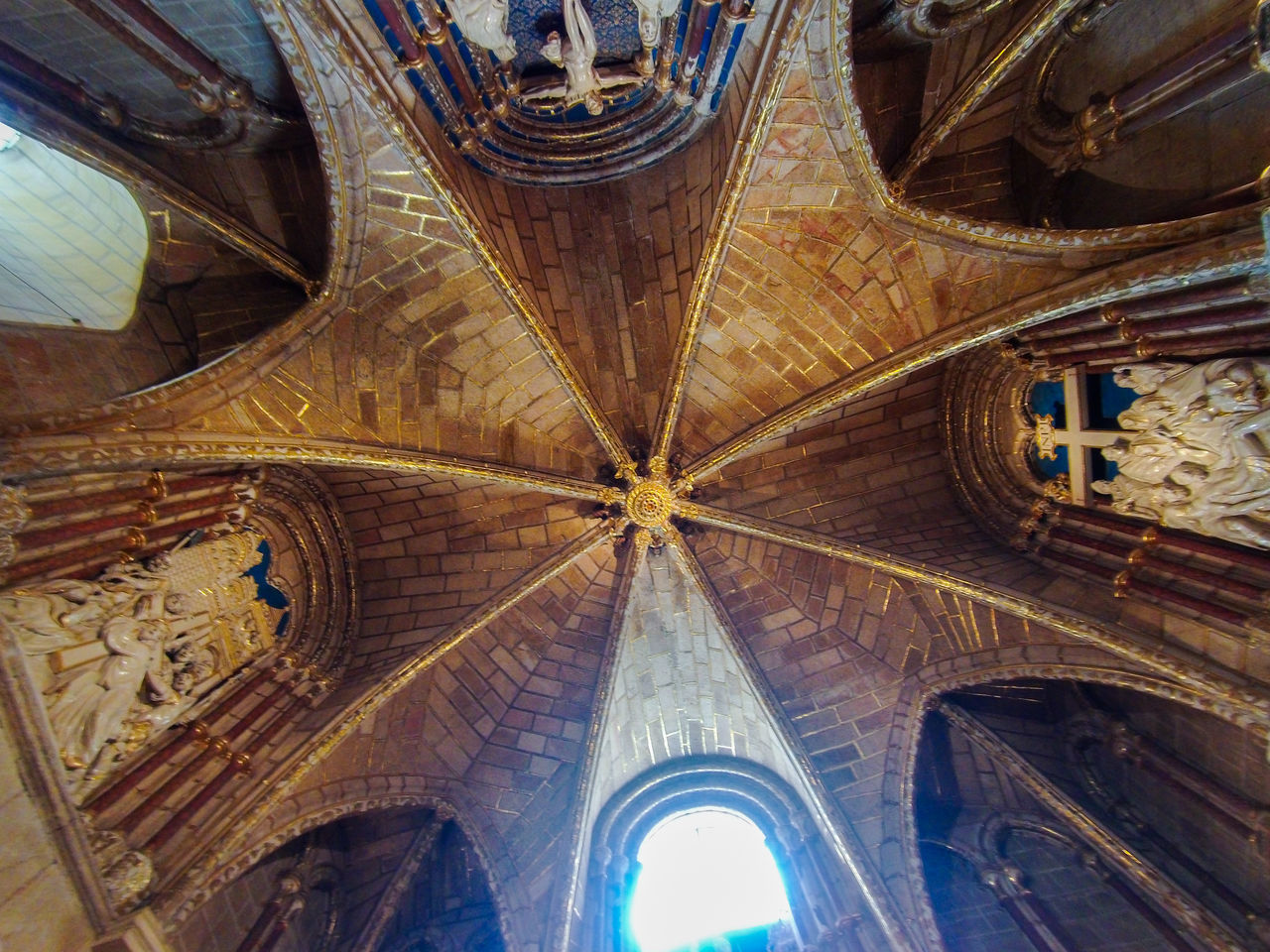 architecture, built structure, place of worship, ceiling, low angle view, religion, indoors, no people, belief, building, spirituality, dome, travel destinations, vault, catholicism, arch, worship, the past, history, pattern, day, ancient history, travel, architectural feature, directly below, art