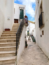 Rear view of man walking on footpath