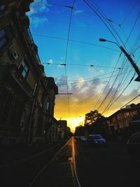 Cars on street at sunset