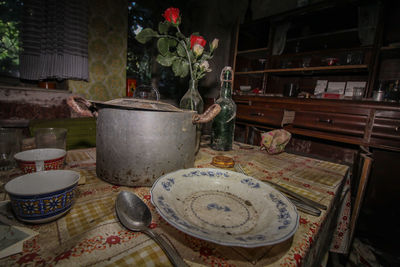 Abandoned kitchen utensils on table at home