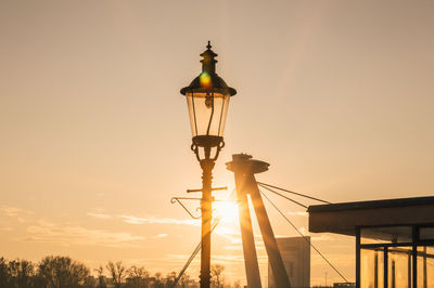 Low angle view of silhouette street light against sky during sunset