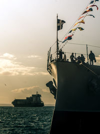Ship sailing on sea against sky during sunset