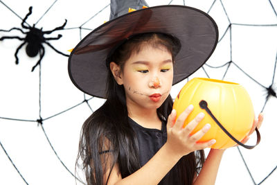 Portrait of girl holding hat