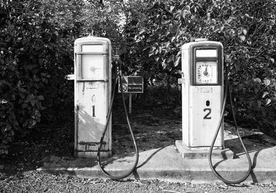 Abandoned gas station against tree