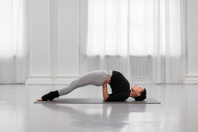 Low section of woman exercising on floor