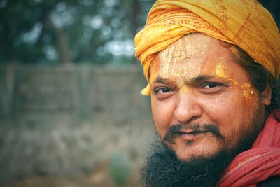 Portrait of smiling mid adult sadhu wearing headscarf