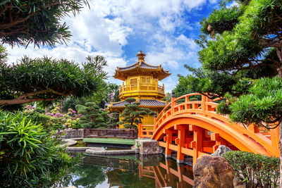 Temple by building against sky