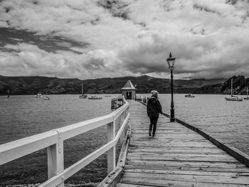 Man standing on sea against sky