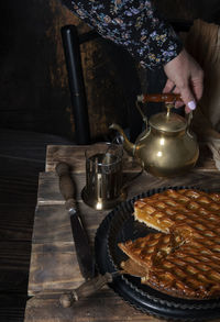 Apricot pie with black tea on wooden table seasonal autumn still life