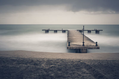 Pier over sea against sky