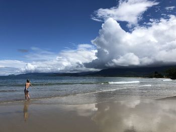 Full length of man on beach against sky