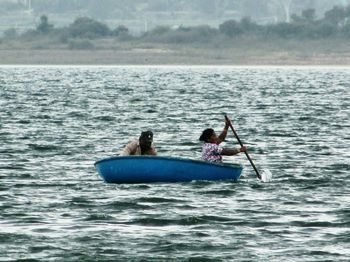 People sitting on boat in sea