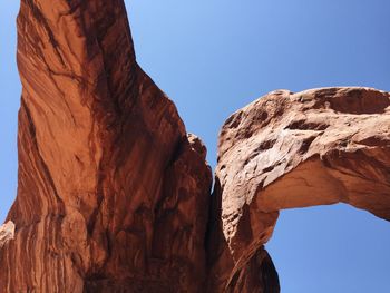 Rock formation against clear blue sky at arches national park