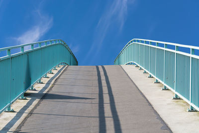 Footbridge against blue sky