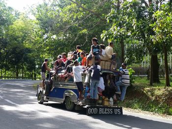 People in vehicle on tree