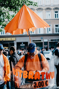 Rear view of people standing in city