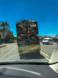 Cars on road against clear blue sky