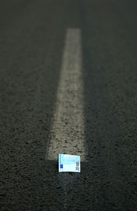 Close-up of arrow sign on road