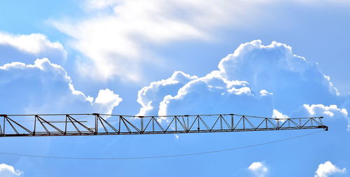 Low angle view of crane against blue sky