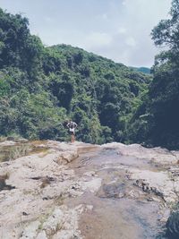 Man on mountain road against sky
