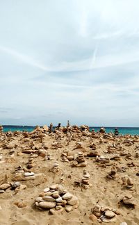 Rocks on beach against sky