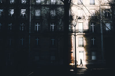 Silhouette of building by street