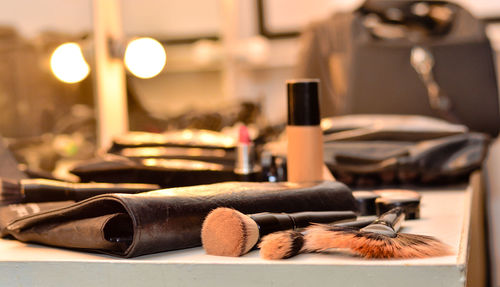 Close-up of make-up brushes and pouch on table