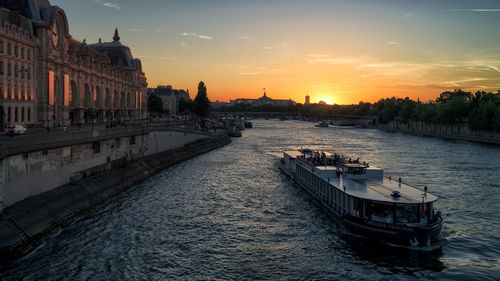 Bridge over river against sky during sunset