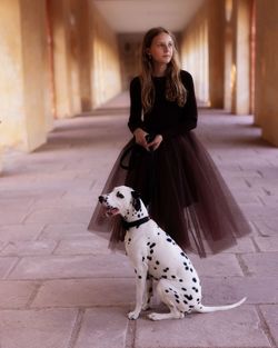 Portrait of young woman with dalmatian dog