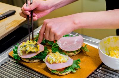 Close-up of woman preparing food on table