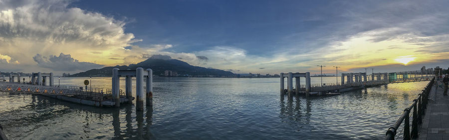 Pier over sea against sky during sunset