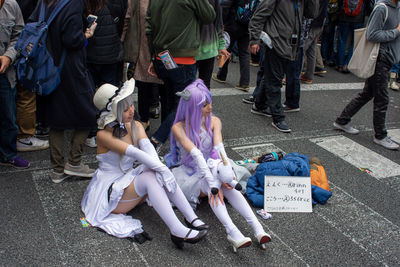 Low section of people standing on street