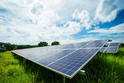 Low angle view of solar panels against sky