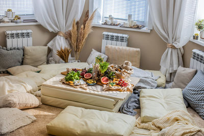 Low angle view of potted plant on bed at home