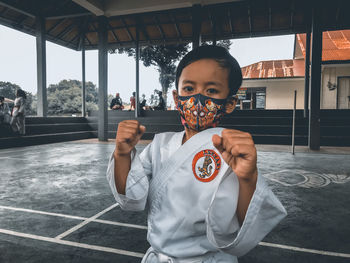 Portrait of smiling boy holding camera