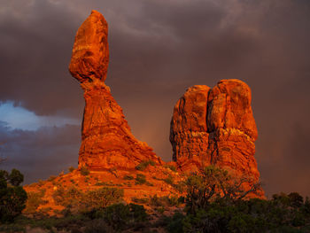 Balanced rock in sunset with dramatic clouds in arches national park, utah, usa