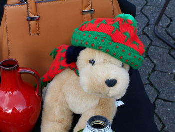 Close-up of knit hat on toy animal at chair