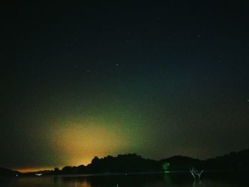 Scenic view of lake against sky at night