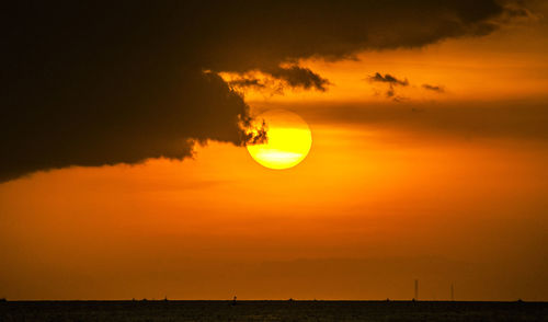 Scenic view of sea against orange sky