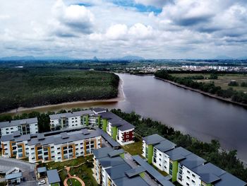 Aerial view of houses in city against sky