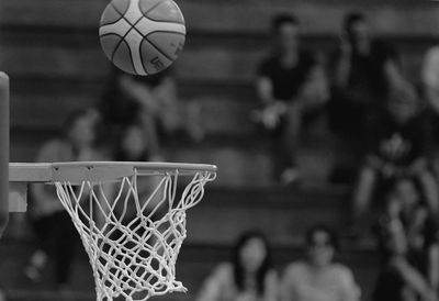 Ball in mid-air over basketball hoop 