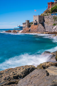 Scenic view of sea and buildings against sky