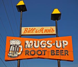 Low angle view of information sign against clear blue sky